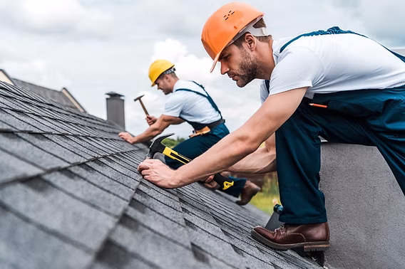Roofing contractor performing asphalt shingle roof repair on a residential home in Manchester, GA